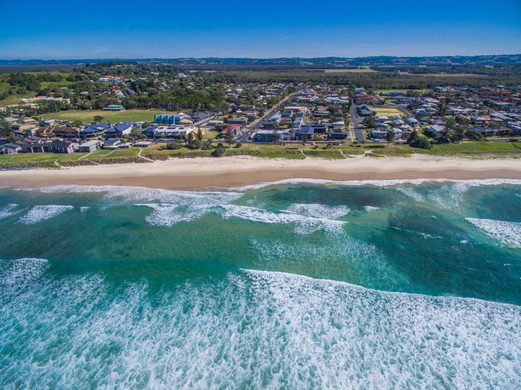 an aerial view of a beach with houses and the ocean at Lennox Holiday Apartments in Lennox Head