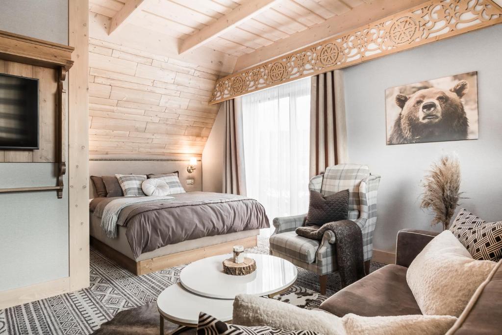 a bedroom with a bed and a living room at Villa Hello Tatry in Zakopane