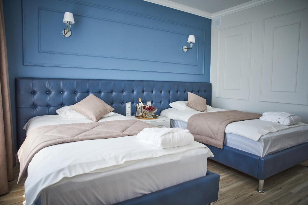 Postel nebo postele na pokoji v ubytování Rakhat Hotel