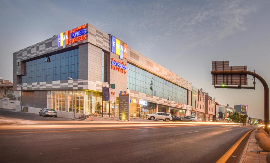 a building on a street with cars parked in front of it at Ewaa Express Hotel - Khurais in Riyadh