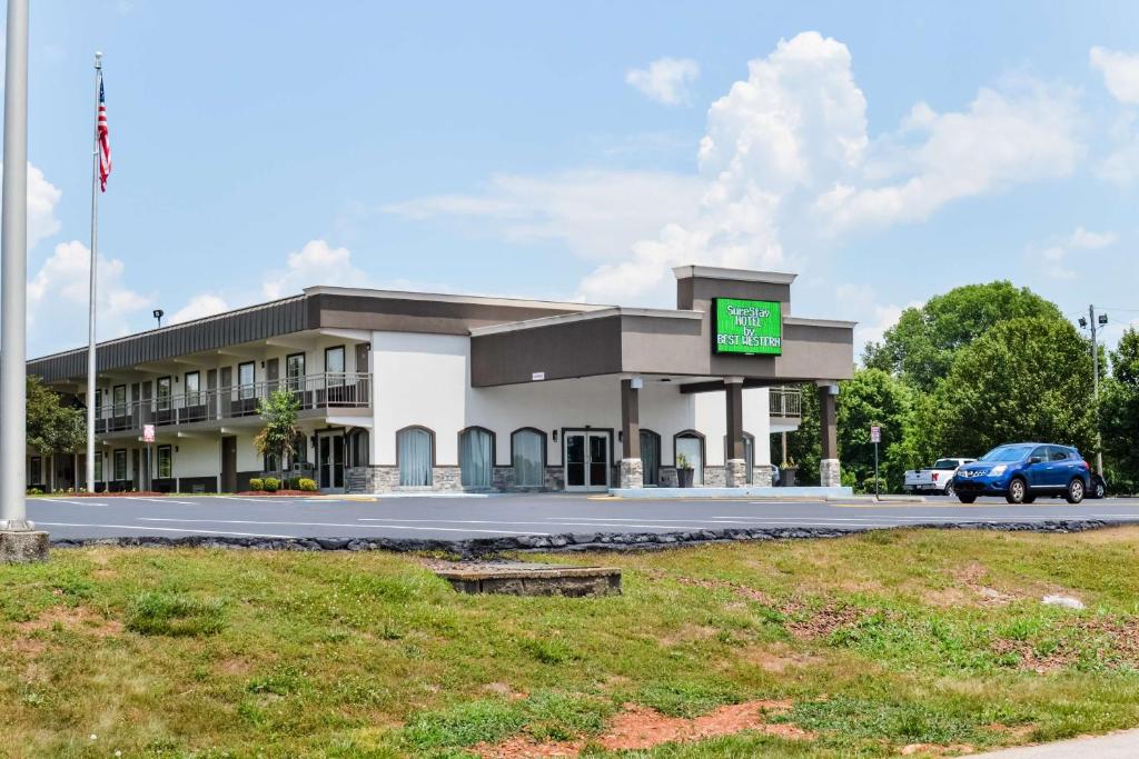 a building with a car parked in front of it at SureStay Hotel by Best Western Bowling Green North in Bowling Green