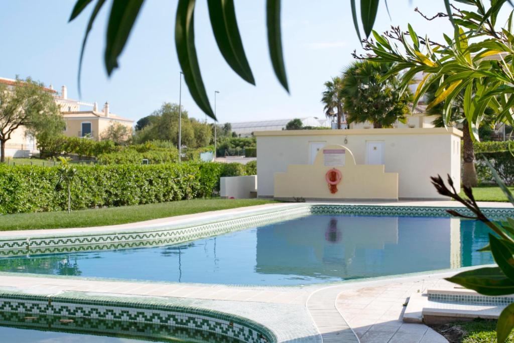 a swimming pool in front of a villa at Pool and Garden Village-near beach in Albufeira