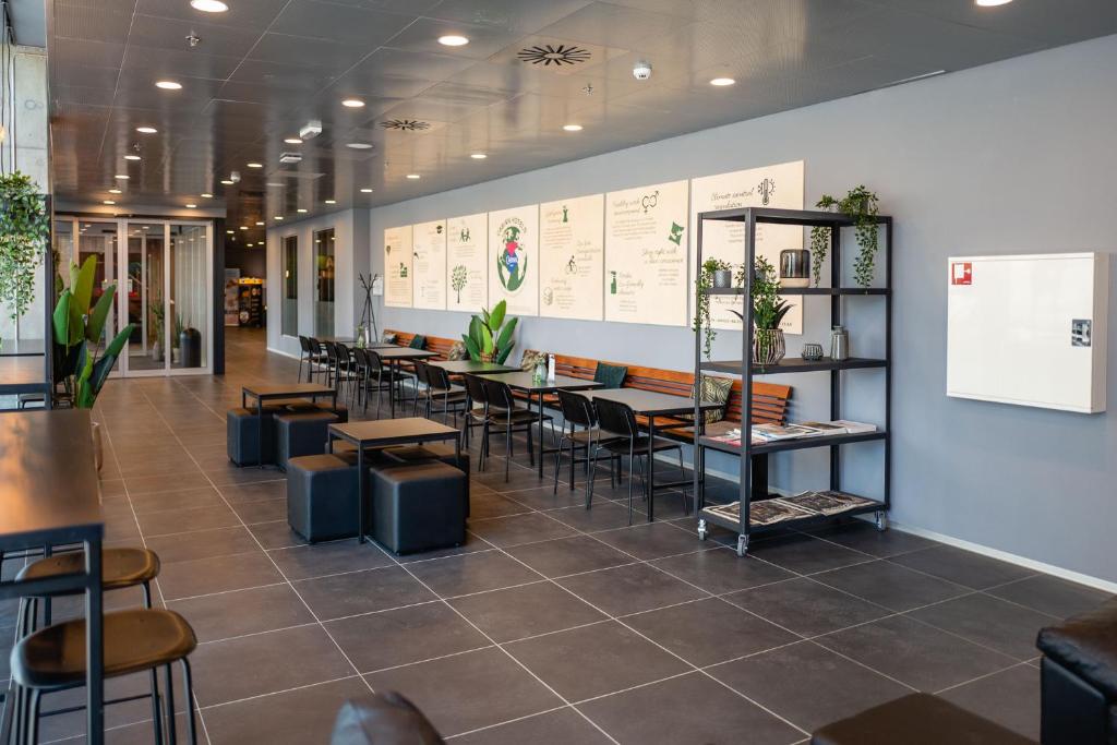 a restaurant with tables and chairs in a room at Cabinn Copenhagen in Copenhagen