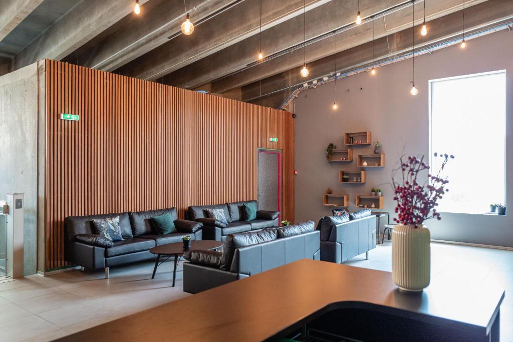 a living room with couches and a table at Cabinn Copenhagen in Copenhagen