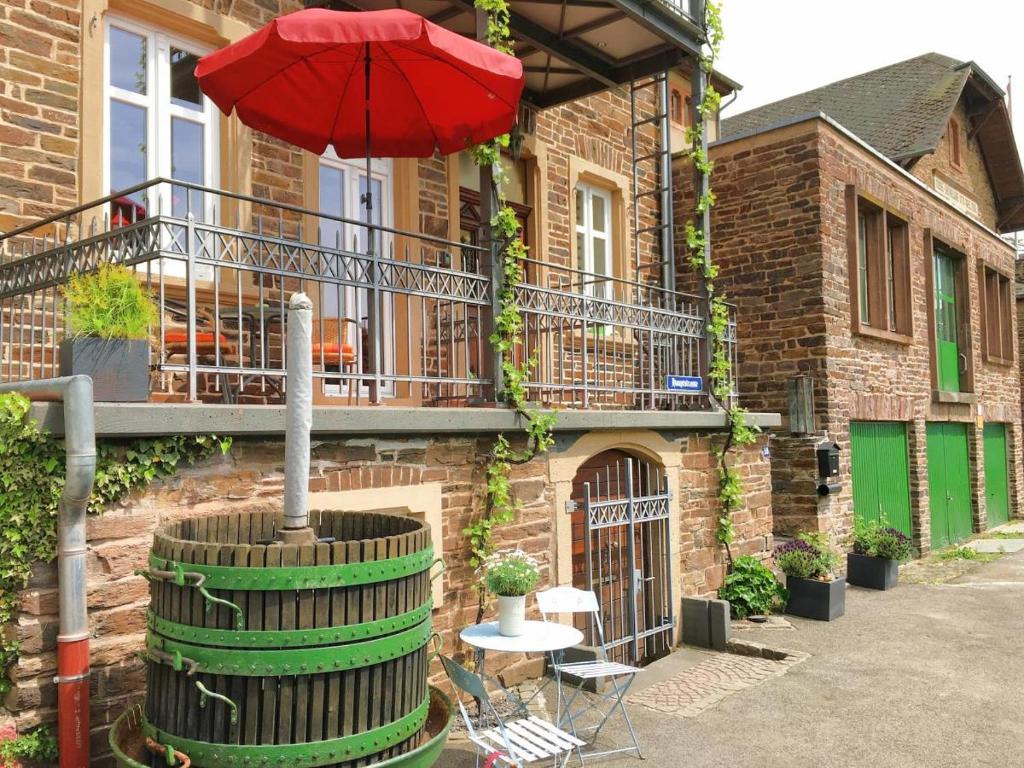 a red umbrella sitting on top of a building at Ferienhaus Moselmerle in Zell an der Mosel