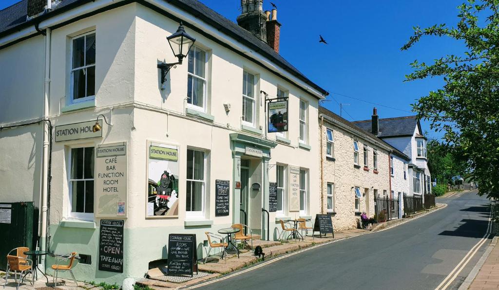 a row of white buildings on a street at Station House, Dartmoor and Coast located, Village centre Hotel in South Brent