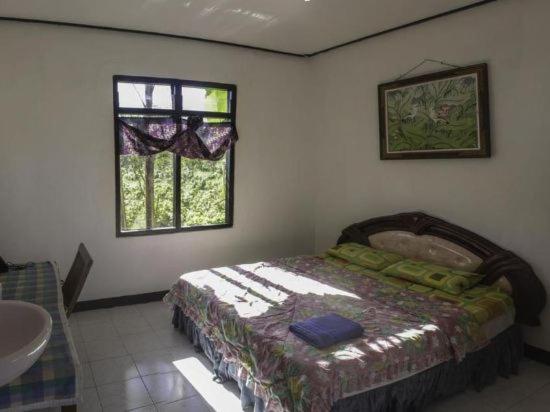 Кровать или кровати в номере Bukit Kembar Ecotourism