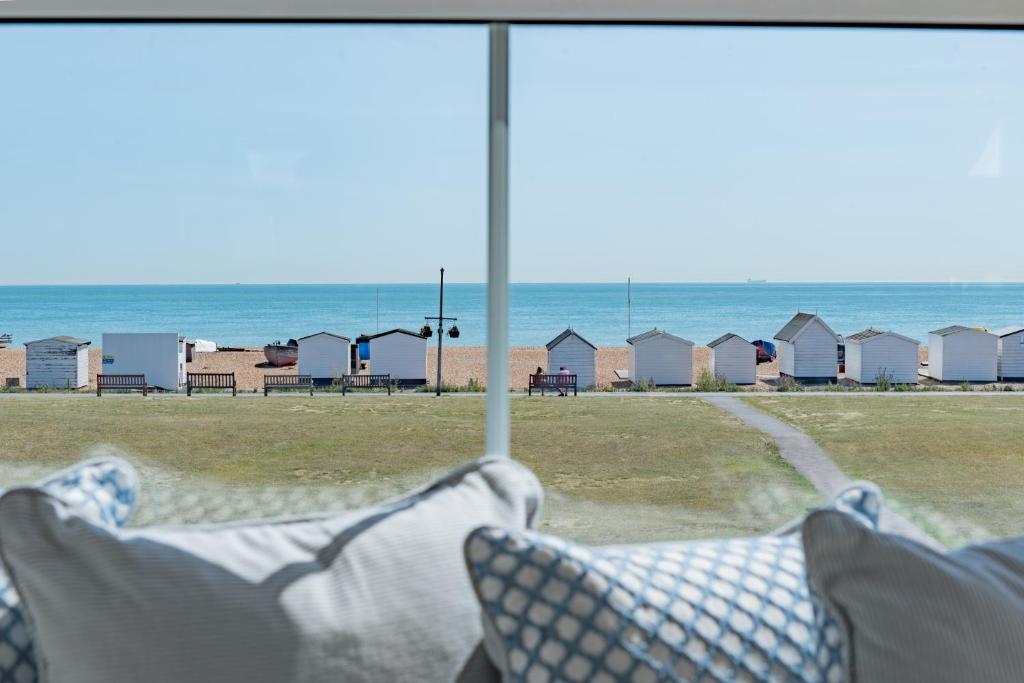 a view of the beach from a room with a window at Boatman's Reading Rooms in Deal