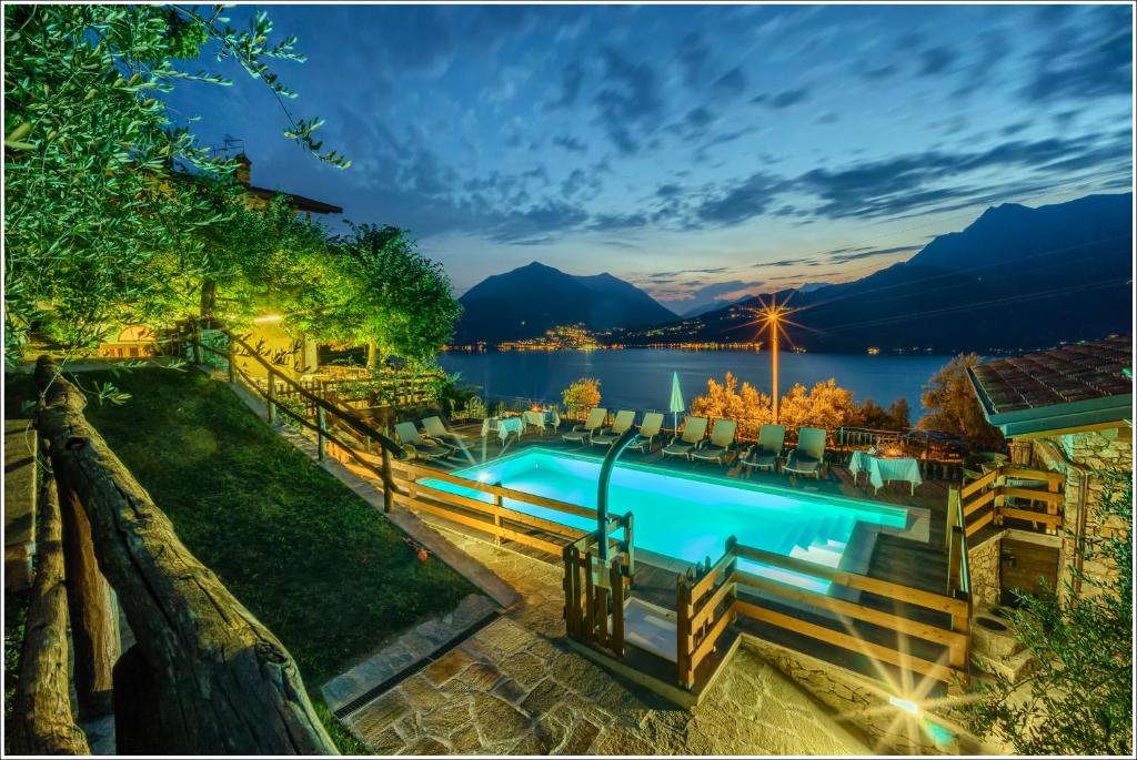 a pool with a view of the water and mountains at Fantastica Casa Poppo in Bellano