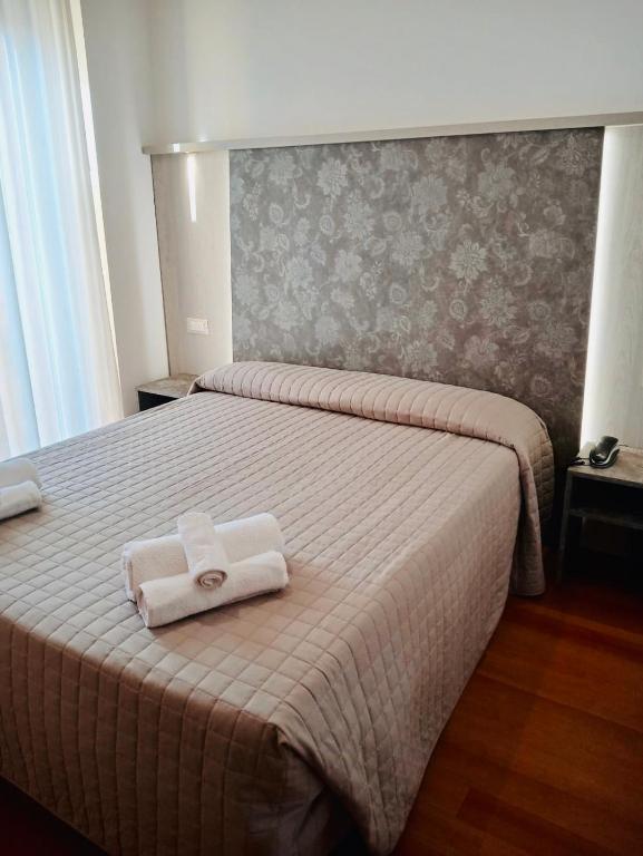 Postel nebo postele na pokoji v ubytování Hotel Monica