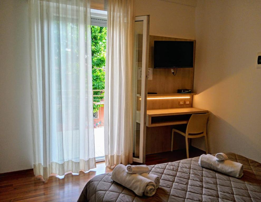 Postel nebo postele na pokoji v ubytování Hotel Monica