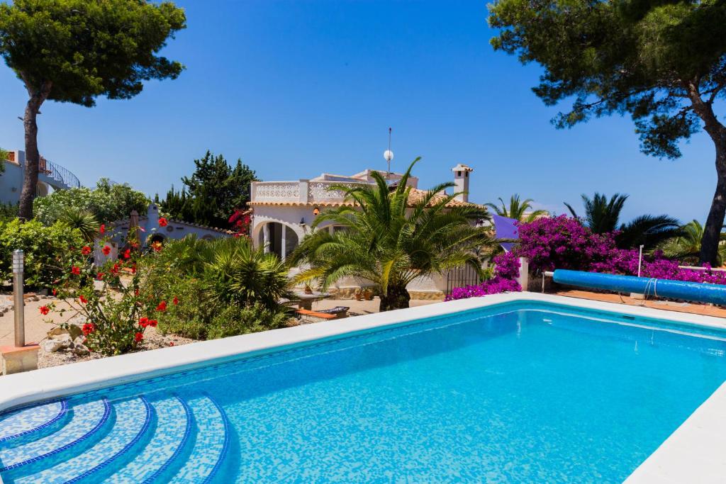 a swimming pool in front of a house at Villa Casa Vincella in Balcon del Mar