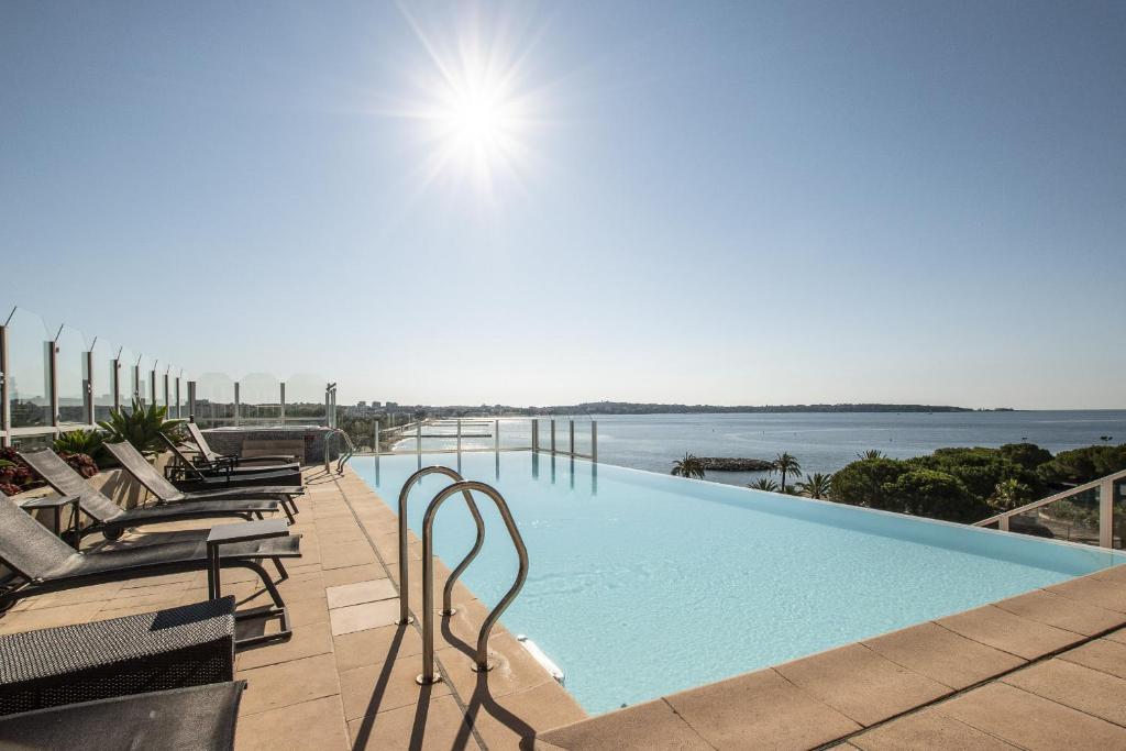 a swimming pool on the roof of a building at Le palais napoleon in Golfe-Juan