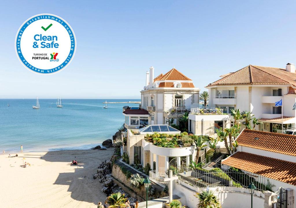 a view of a house on the beach with the clean safe logo at The Albatroz Hotel in Cascais