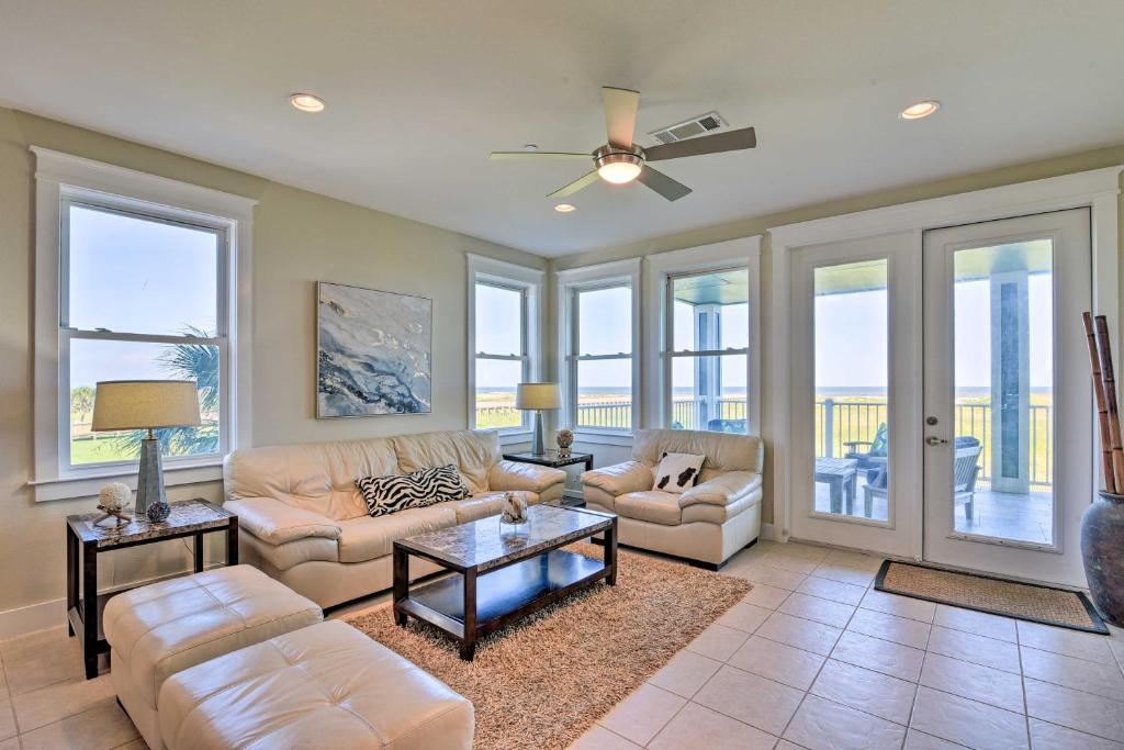 a living room with a couch and a table at Gulf View and Beach Access Galveston Resort Condo! in Galveston