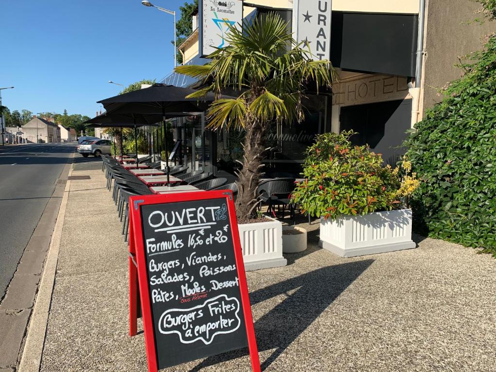 a sign on the sidewalk in front of a restaurant at La Locomotive in Issoudun