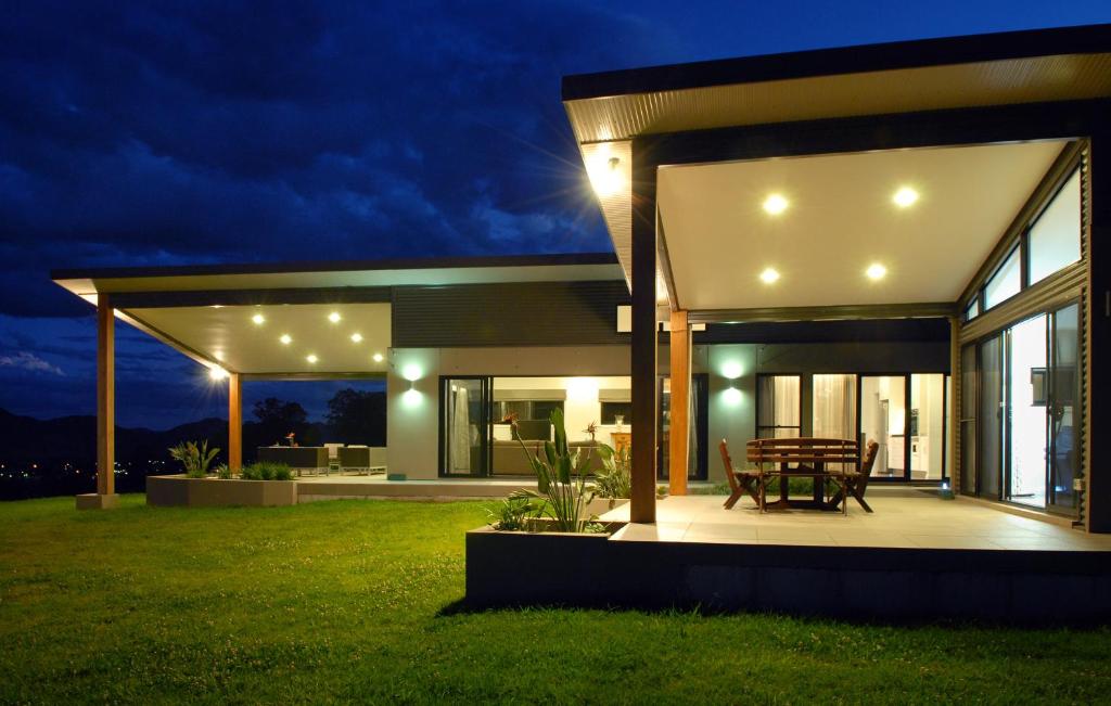 a modern house with a patio at night at The Ridge Gloucester in Gloucester