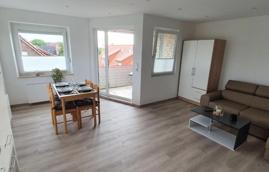 a living room with a couch and a table at Ferienwohnung Strandjuwel am Strand in Norddeich