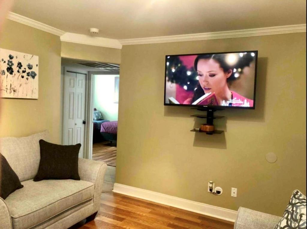 a living room with a flat screen tv on a wall at Trinity One Apartments - Tranquility Luxury in Jackson