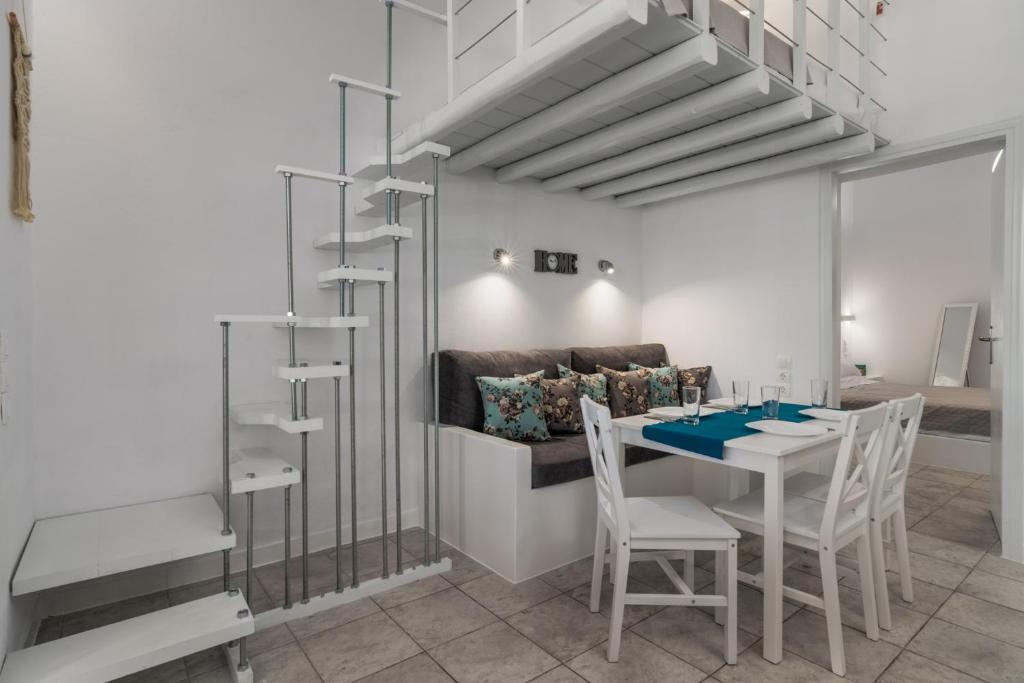 a dining room with a table and chairs and a couch at Aretis home in Plaka Milou