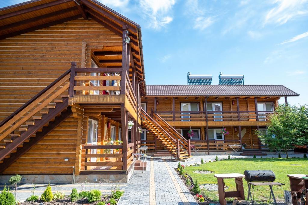 a log house with stairs leading up to it at Rybatska 7 in Chornomorsk