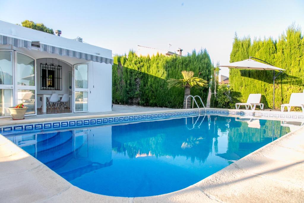 a swimming pool in front of a house at Villa Ana in Moraira