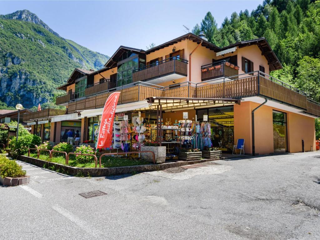 a building with a store in front of a mountain at Apartment in Ledro by Lake & Dolomites in Ledro
