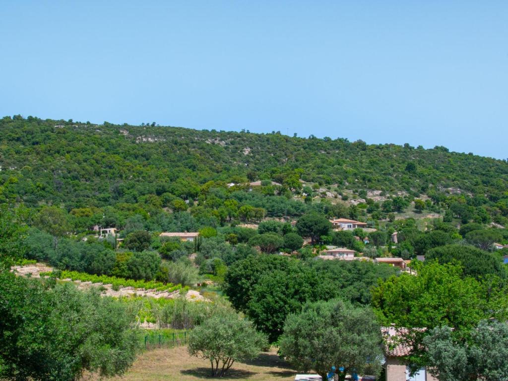 a view of a hill with trees and houses at Cosy villa with private pool in Emponse