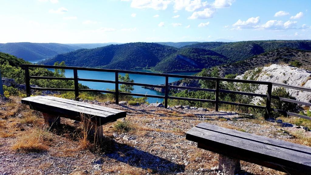 a bench sitting on top of a mountain with a view at Village House Fafarinka - close to Krka National Park in Konjevrate