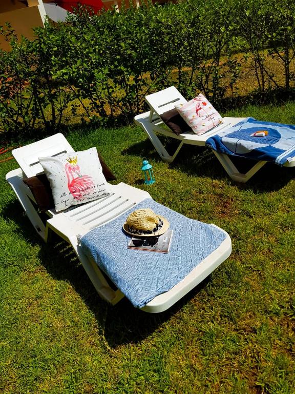 two beds sitting on the grass in the yard at FamilyConfort Saidia in Saïdia