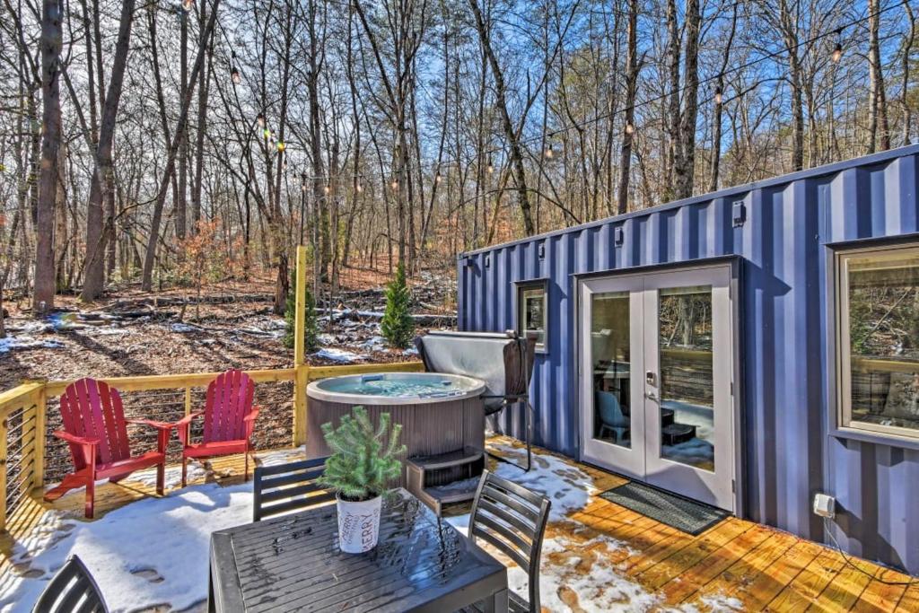 a blue tiny house with a table and chairs at The Container at Camp Toccoa in Blue Ridge