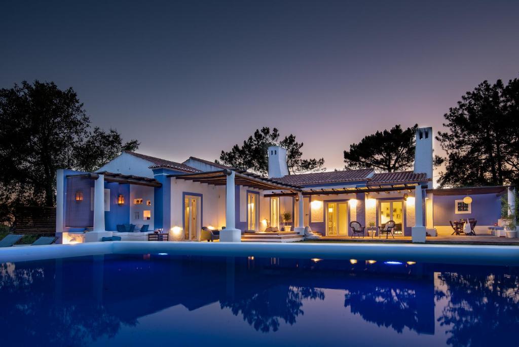 a house with a swimming pool at night at Herdade do Frei Cuco in Santiago do Cacém