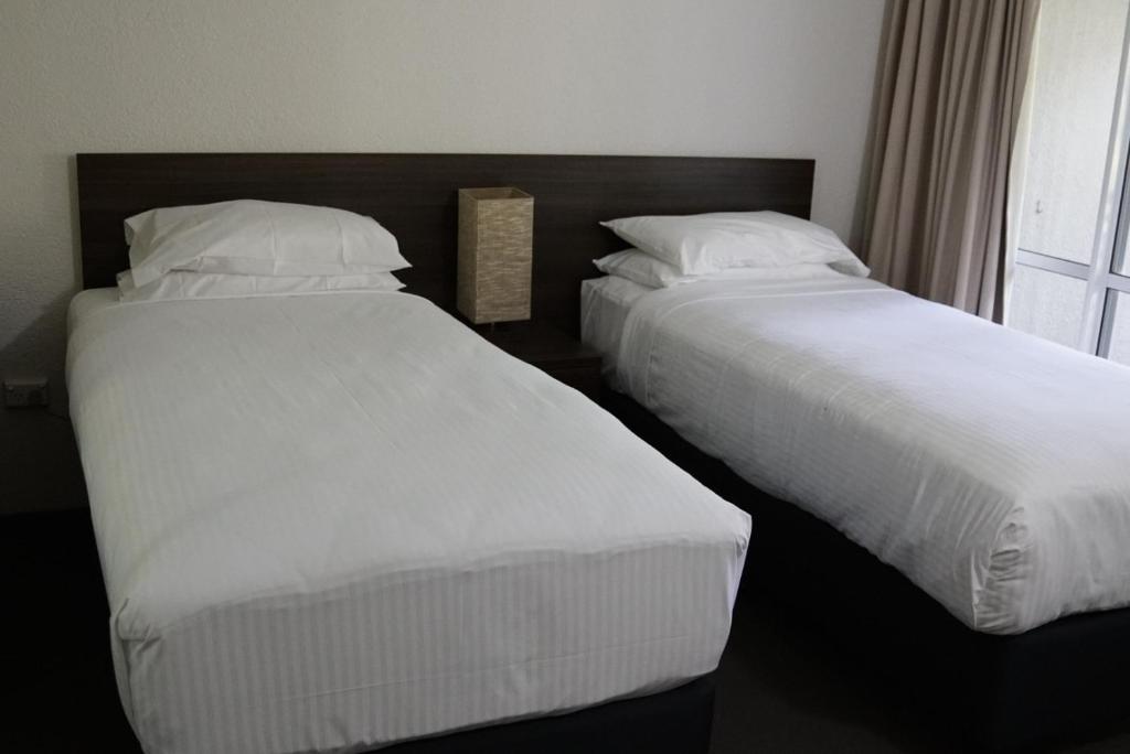 Postel nebo postele na pokoji v ubytování Reef Resort Villas Port Douglas