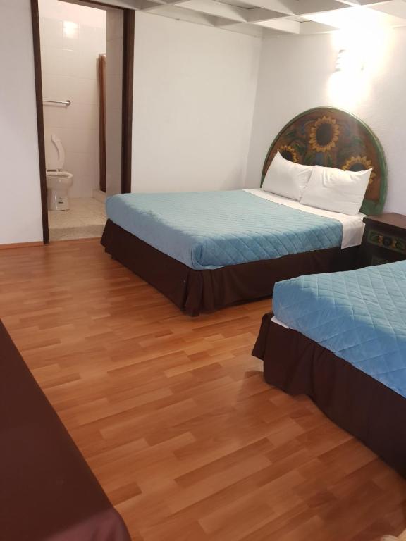 Postel nebo postele na pokoji v ubytování Hotel Meson Mariano Matamoros