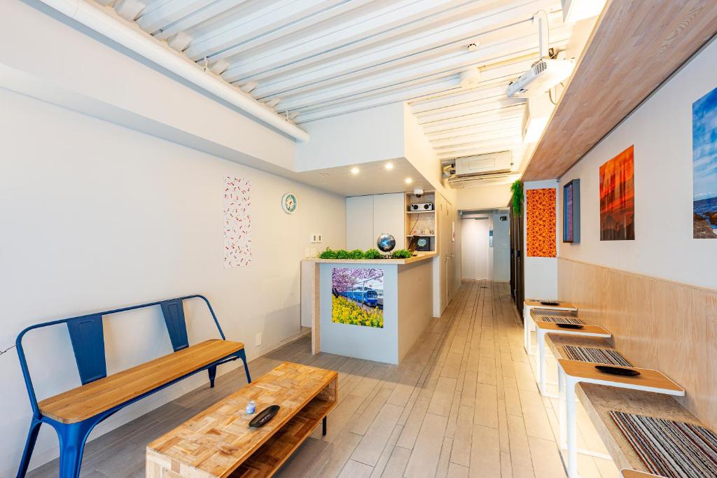 a living room with a bench and a table at plat hostel keikyu asakusa station in Tokyo
