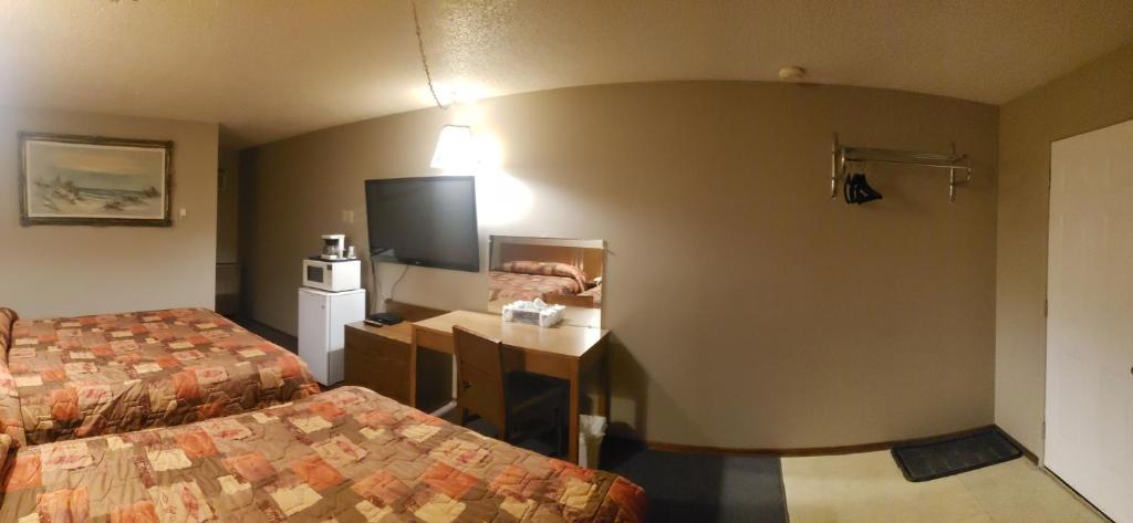 Postel nebo postele na pokoji v ubytování Sunset Motel
