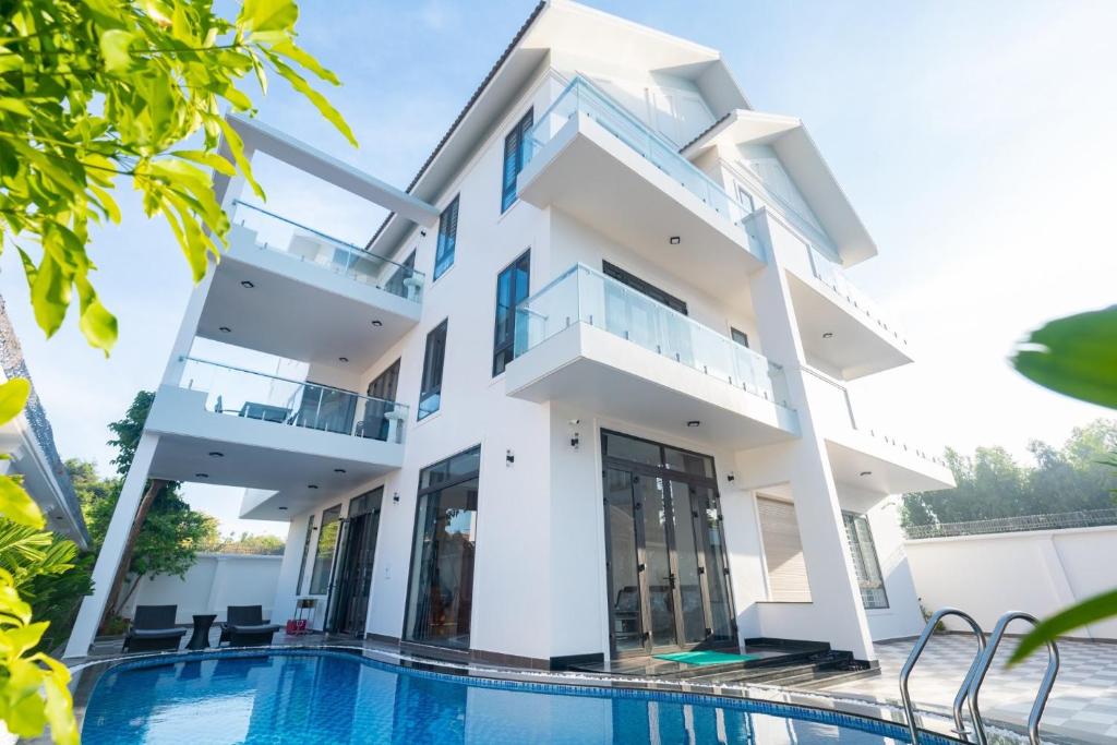 a villa with a swimming pool in a resort at Palm Villa 29 (Luxury) in Vung Tau