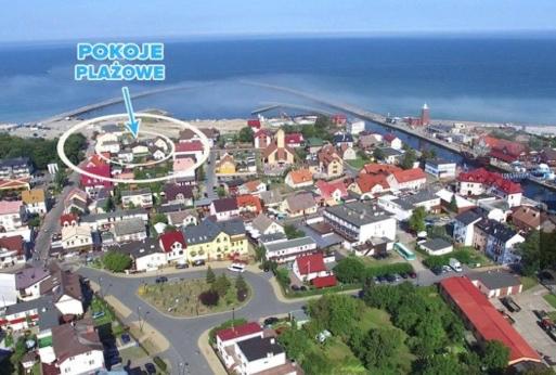 an aerial view of a small town near the ocean at Domki i POKOJE PLAŻOWE in Darlowko