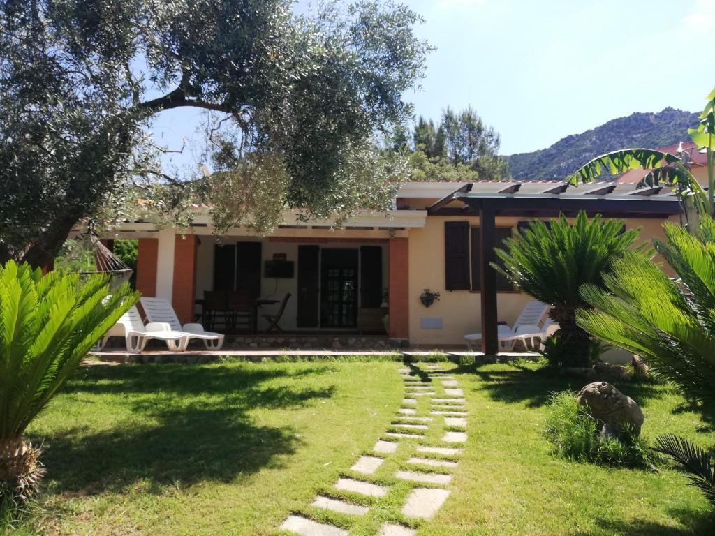 a house with a garden and a walkway at Villa REBECCA in Solanas