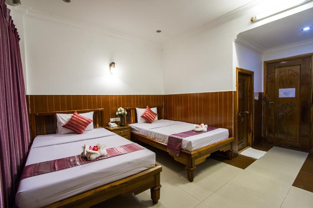 Postel nebo postele na pokoji v ubytování Botoum Hotel