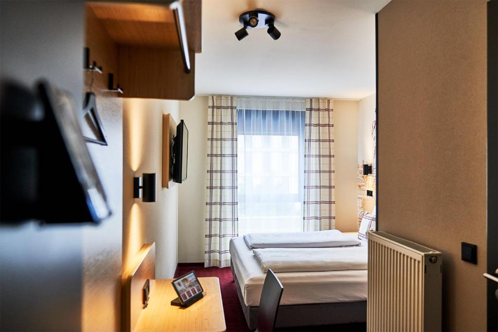 Postel nebo postele na pokoji v ubytování McDreams Hotel München - Messe