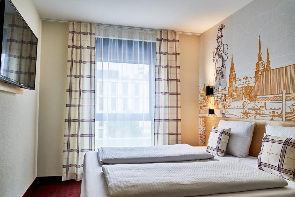 Postel nebo postele na pokoji v ubytování McDreams Hotel München - Messe
