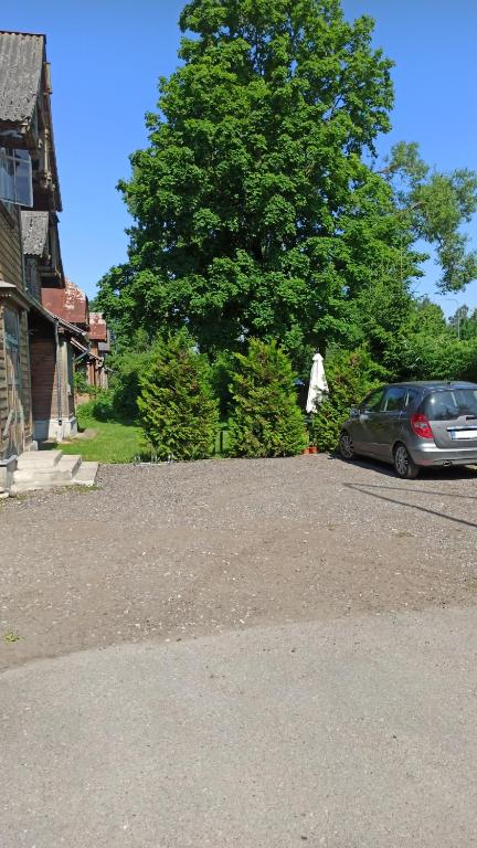 a car parked in a driveway next to a house at Riia 141 Apartment in Pärnu