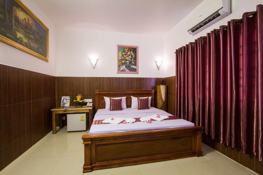 Postel nebo postele na pokoji v ubytování Botoum Hotel