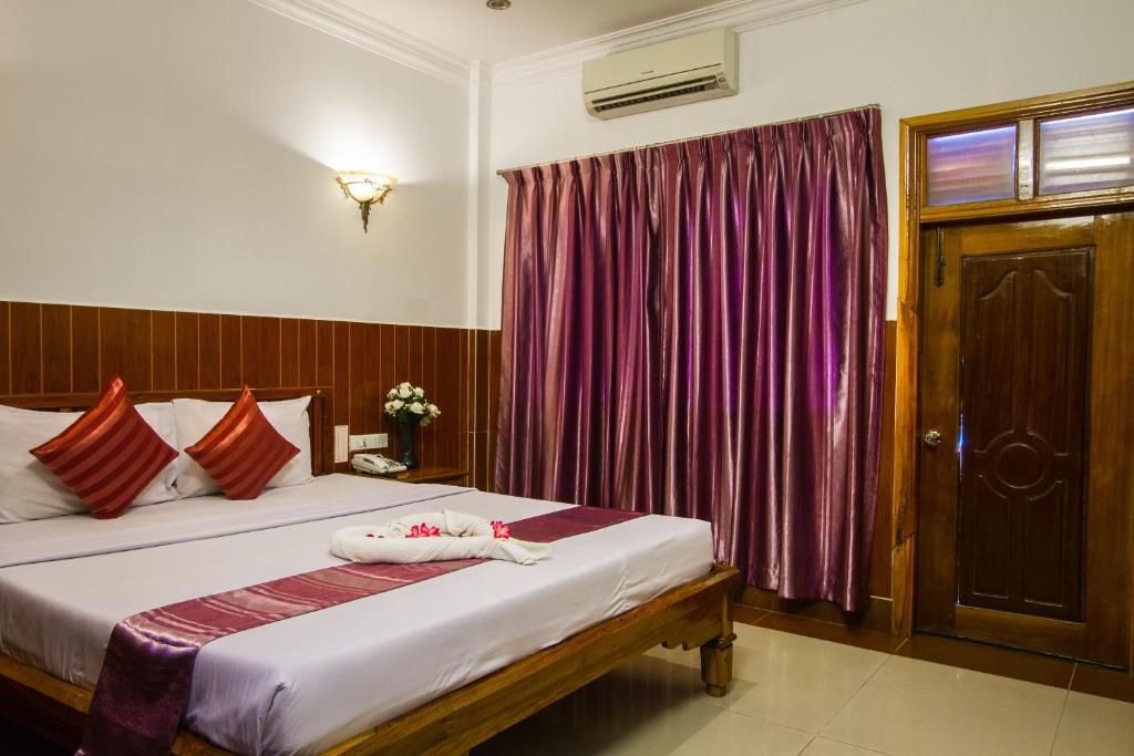Postel nebo postele na pokoji v ubytování Botoum Hotel