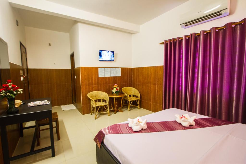Postel nebo postele na pokoji v ubytování Botoum Hotel