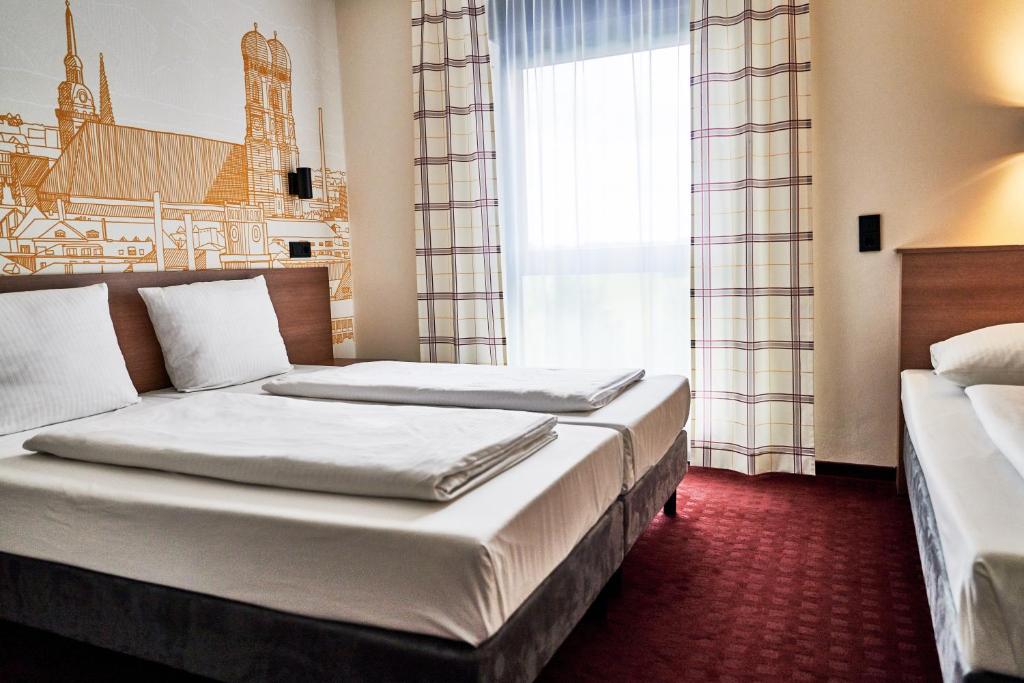 Postel nebo postele na pokoji v ubytování McDreams Hotel München - Messe