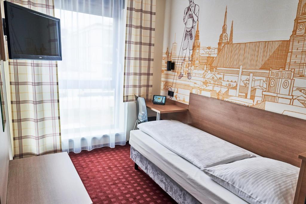 Postel nebo postele na pokoji v ubytování McDreams Hotel München - Messe