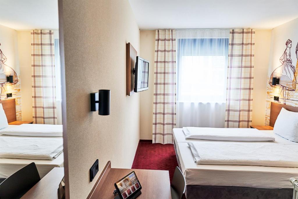 Postel nebo postele na pokoji v ubytování McDreams Hotel München - Messe