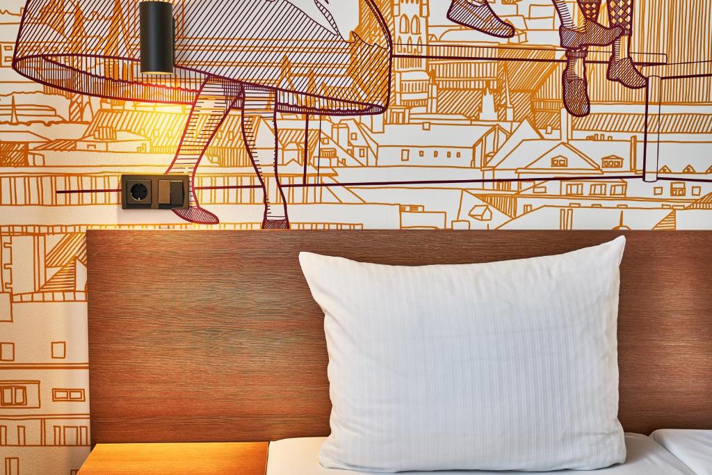 Postel nebo postele na pokoji v ubytování McDreams Hotel München - Messe